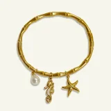Marina ocean charm bracelet for women, Beach charm bracelet gold, Gold charm bracelet online India, AMOHABOLD ocean bracelet, Summer jewellery bracelet for women, Vacation inspired gold bracelet, Anti tarnish charm bracelet, Coastal jewellery for women, Trendy charm bracelet, Gold plated beach bracelet