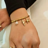 Marina ocean charm bracelet for women, Beach charm bracelet gold, Gold charm bracelet online India, AMOHABOLD ocean bracelet, Summer jewellery bracelet for women, Vacation inspired gold bracelet, Anti tarnish charm bracelet, Coastal jewellery for women, Trendy charm bracelet, Gold plated beach bracelet